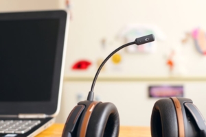 A headset lying next to a laptop